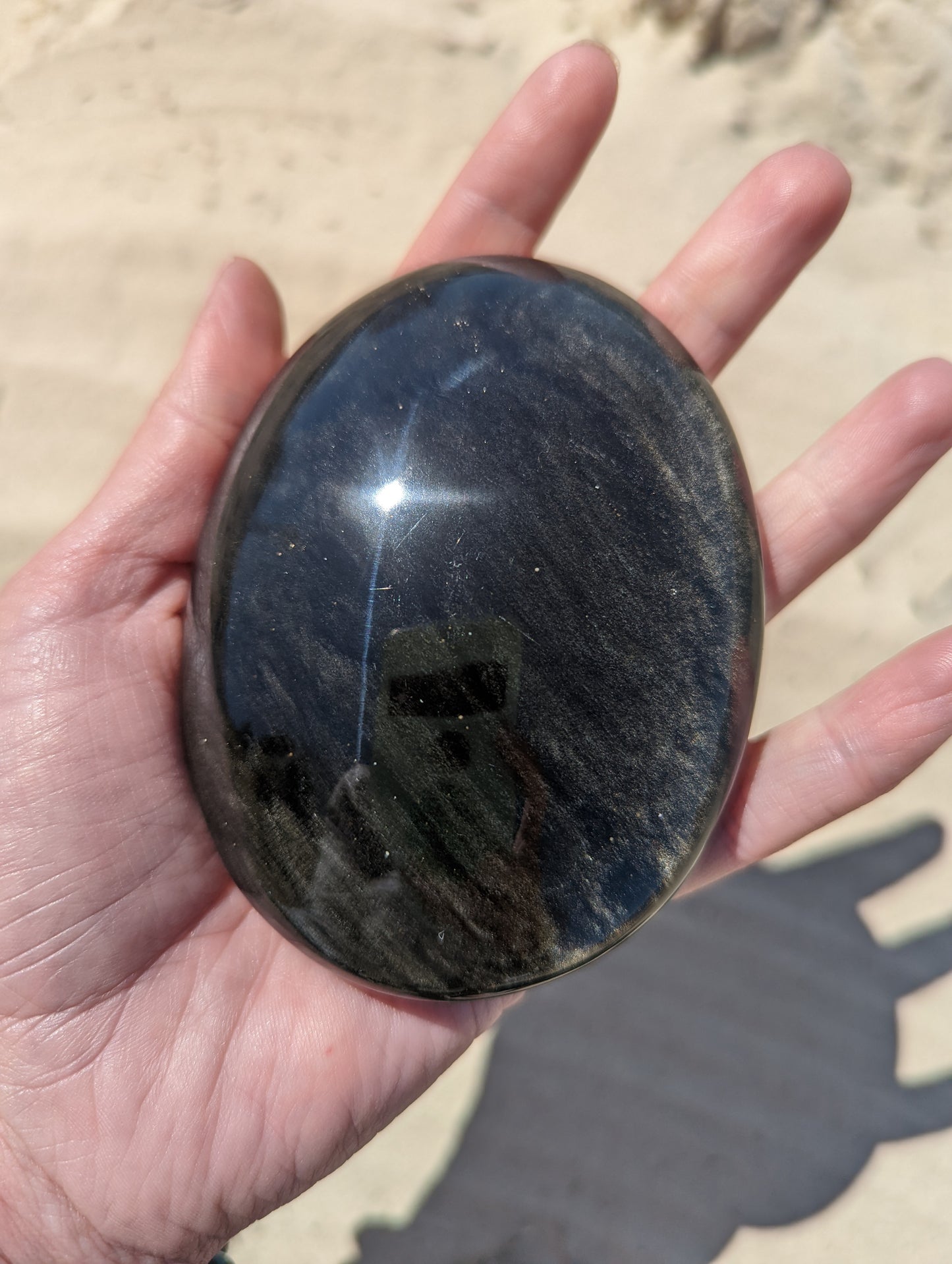 Gold sheen obsidian palm