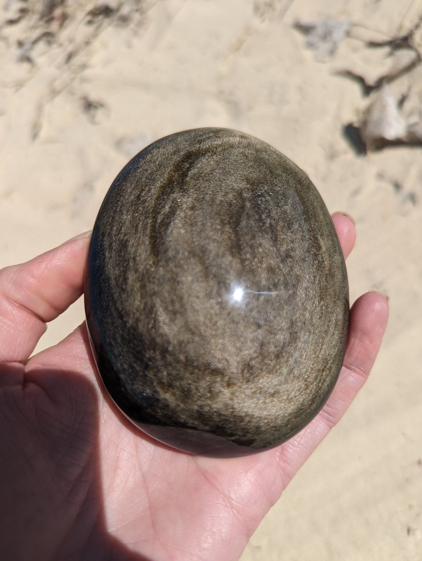 Gold sheen obsidian palm